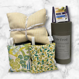 Gift set with pillows and a container labeled 'Mr Fred' on a marble surface